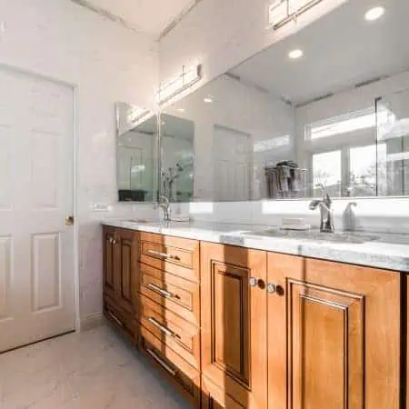 kitchen remodel with natural light, white tile, and wood cabinets