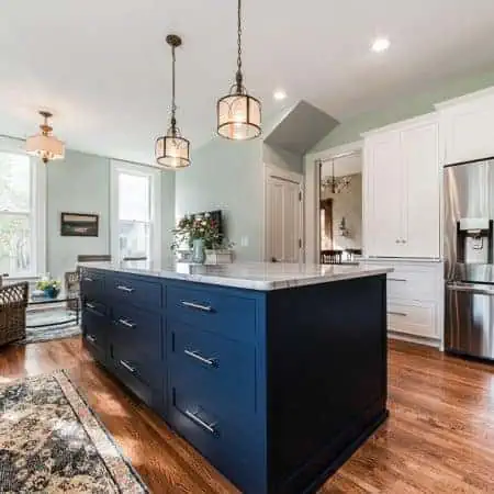White kitchen remodel with navy blue island