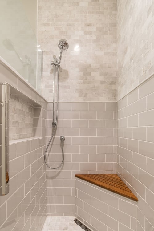 ada bathroom remodel with safety rods and seat in shower