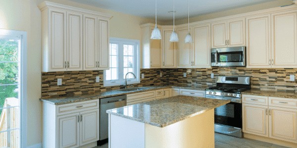 brand new white kitchen with granite island