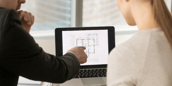 designer sitting with client going over design plans