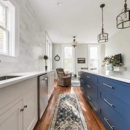 white kitchen remodel with blue island and marble counter tops