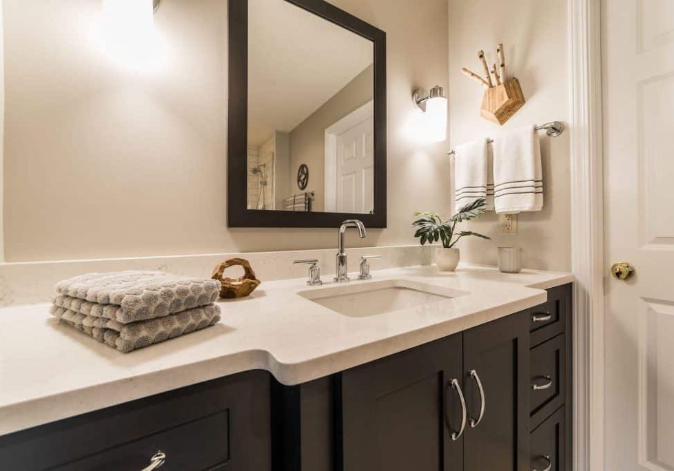 bathroom remodel with mirror and cabinet
