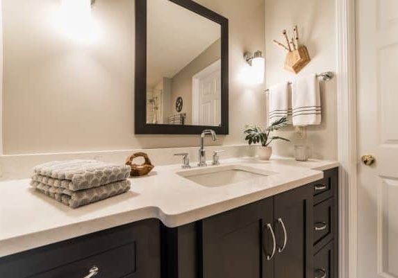bathroom remodel with mirror and cabinet